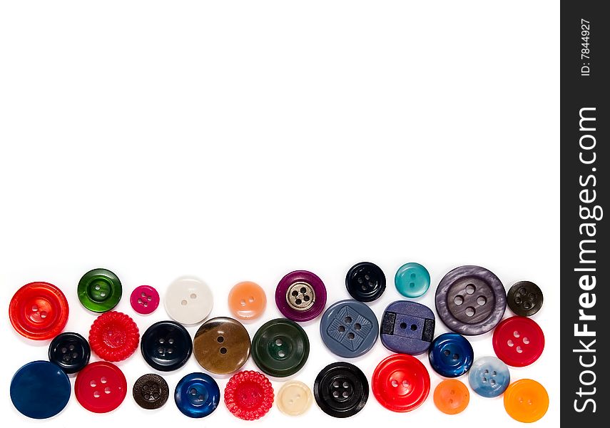 Colored sewing buttons in a line on a white background. Colored sewing buttons in a line on a white background