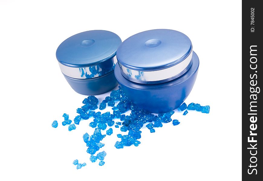 Creams and blue bath salt on a white background. Creams and blue bath salt on a white background