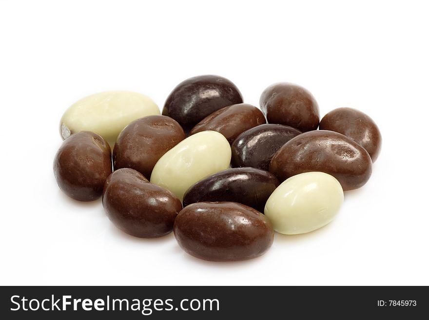 Small oval almond chocolates  on bright background. Small oval almond chocolates  on bright background