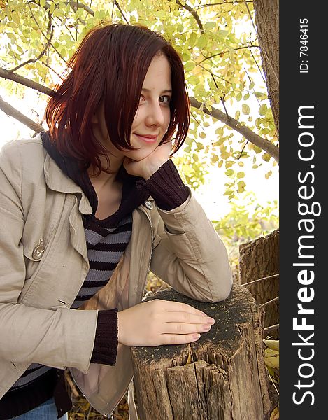 Stump and smiling girl in forest