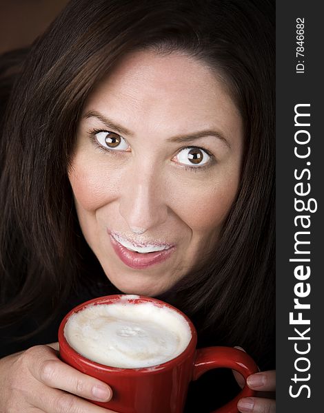 Woman with foam from coffee specialty drink on her lip and nose. Woman with foam from coffee specialty drink on her lip and nose