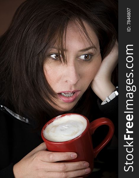 Half awake woman cradling a mug of coffee. Half awake woman cradling a mug of coffee