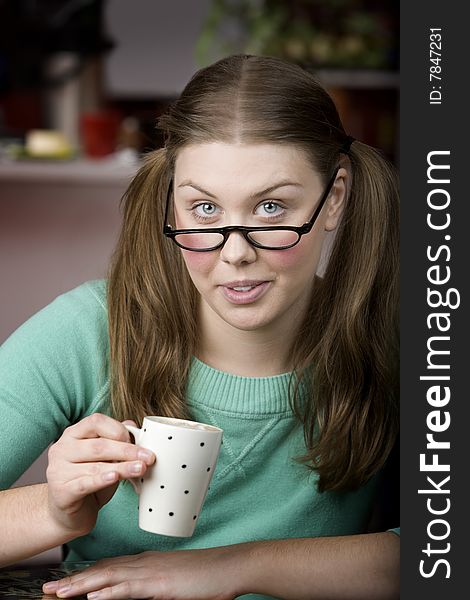 Pretty young woman with glasses and small coffee cup. Pretty young woman with glasses and small coffee cup