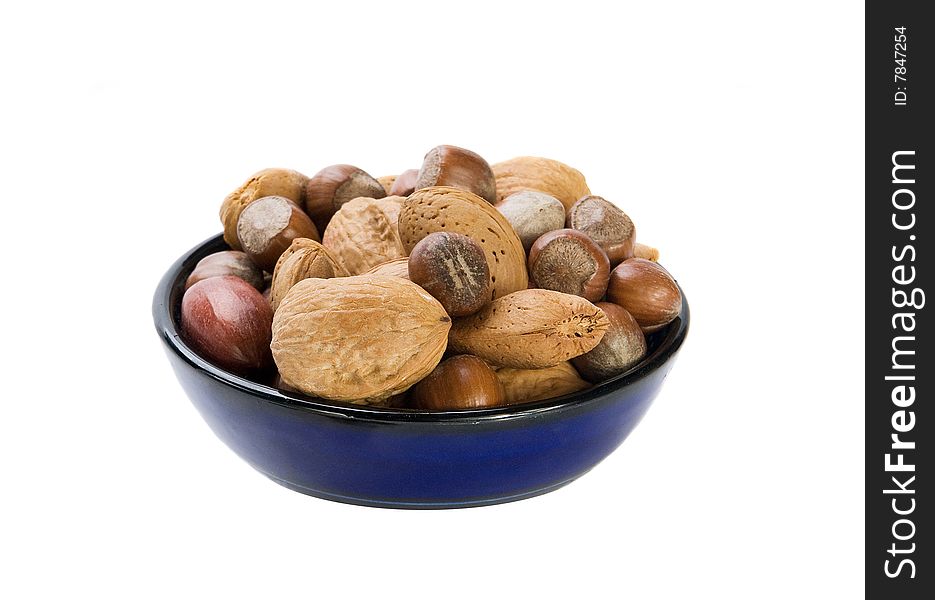 Nuts mix in blue plate on white background