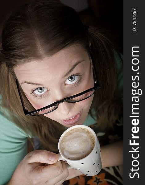 Pretty young woman with glasses and small coffee cup. Pretty young woman with glasses and small coffee cup