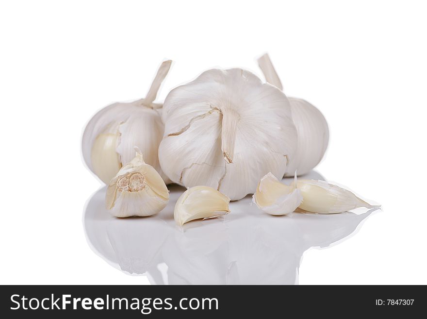 Bunch of whole garlic isolated on white with soft reflection