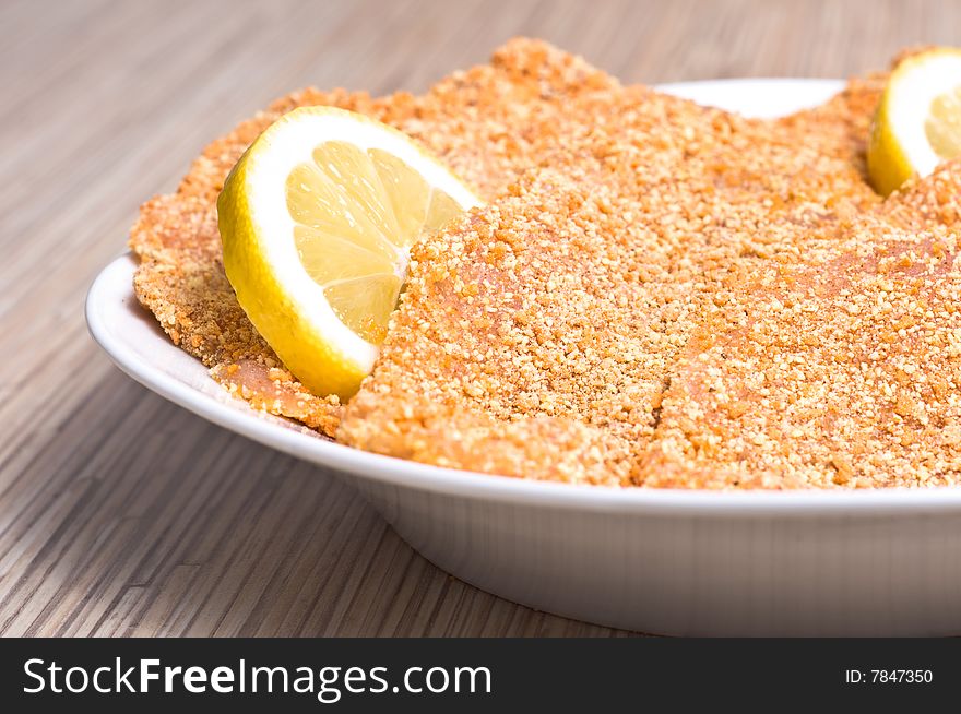 Preparing cutlets from the chicken breast. Chicken breast coated in breadcrumbs.