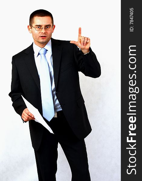 Young businessman on isolated background pointing with his finger