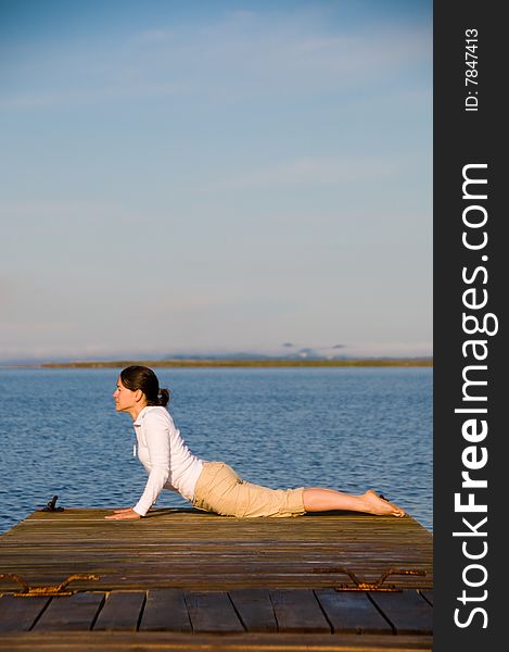 Yoga Woman on a dock by the ocean