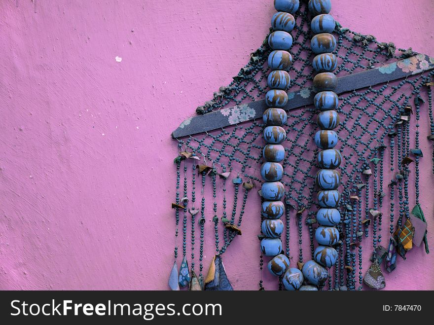 Big old rosary on pink background