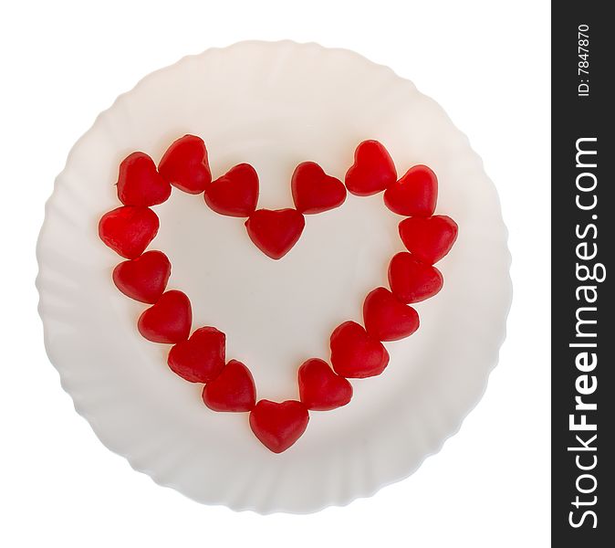 Heart shaped fruit jellies on plate, isolated on white