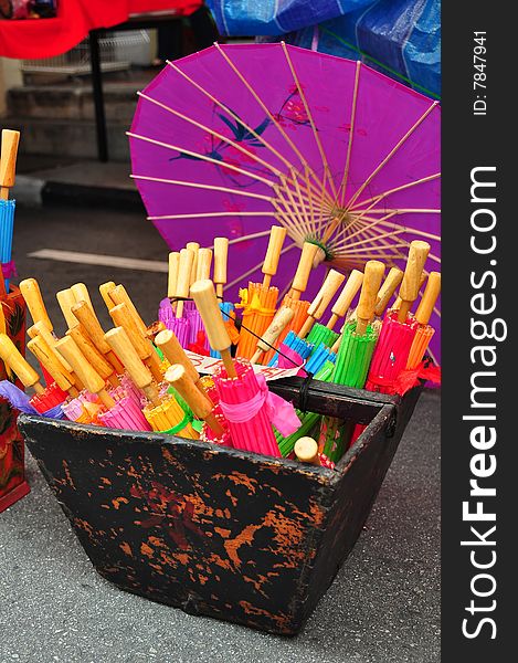 Colorful traditional umbrellas in a basket. Colorful traditional umbrellas in a basket