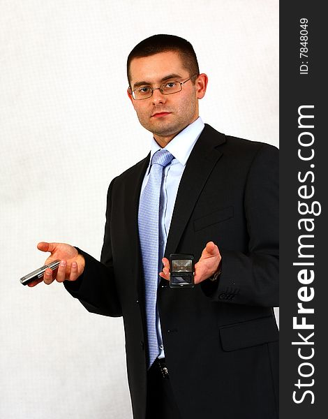 Young businessman on isolated background with a cell phones. Young businessman on isolated background with a cell phones