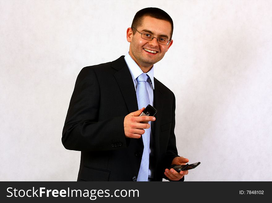 Young businessman on isolated background with his cell phone. Young businessman on isolated background with his cell phone