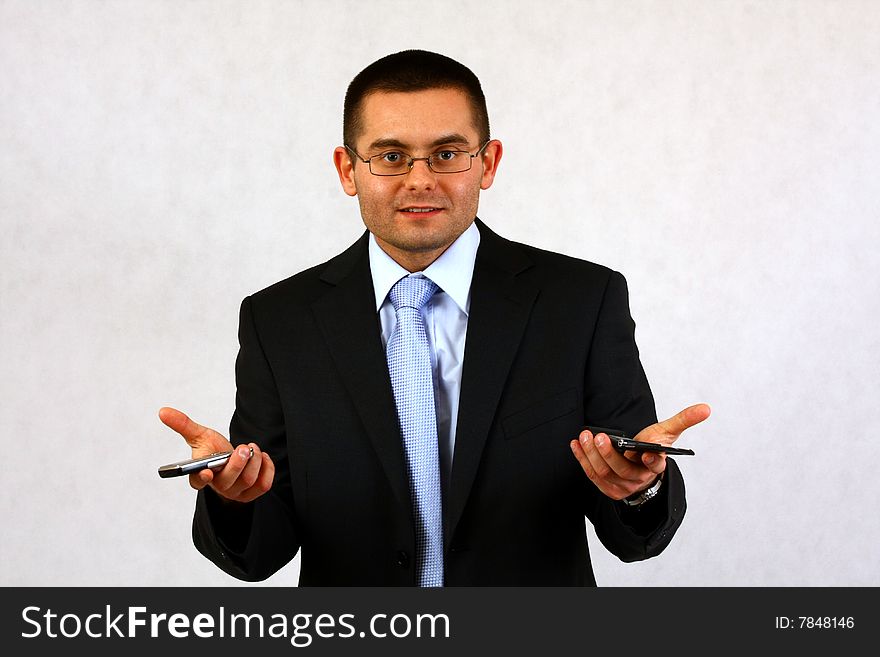 Young businessman on isolated background with a cell phones. Young businessman on isolated background with a cell phones