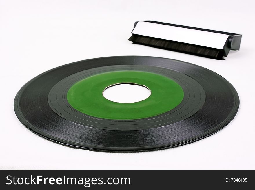 Green record and vinyl brush