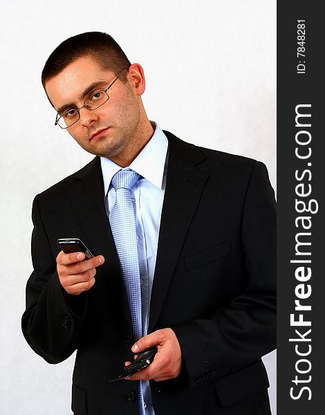 Young businessman on isolated background with a cell phones. Young businessman on isolated background with a cell phones