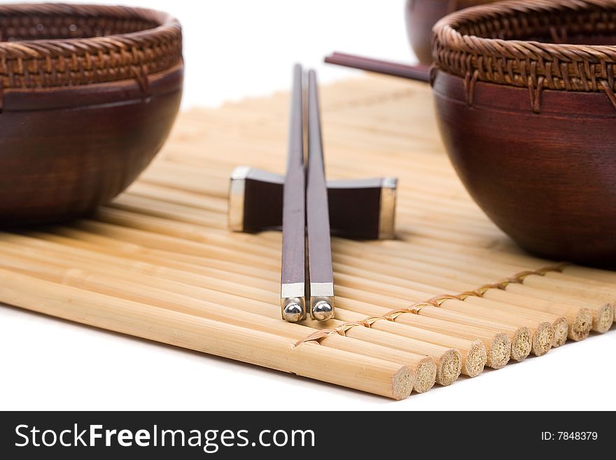 Wood empty bowl and chopsticks on bamboo mat. Wood empty bowl and chopsticks on bamboo mat