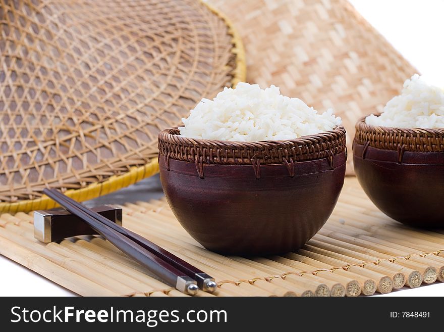Wood rice bowl and chopsticks on bamboo mat. Wood rice bowl and chopsticks on bamboo mat