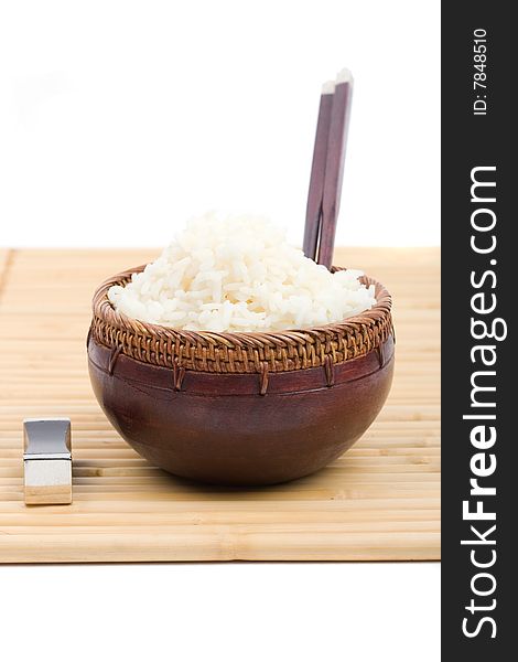 Wood rice bowl and chopsticks on bamboo mat. Wood rice bowl and chopsticks on bamboo mat