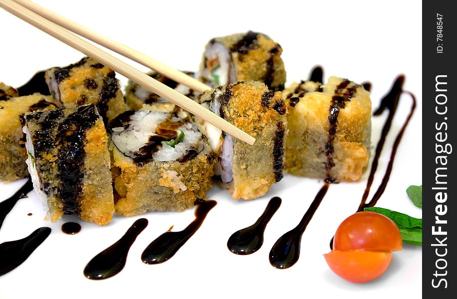 Appetizing rolls watered with soya sauce. A photo close up.