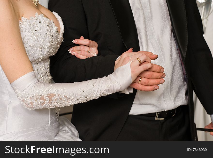 Gentle relations of a newly-married couple and their bound hands. Gentle relations of a newly-married couple and their bound hands.