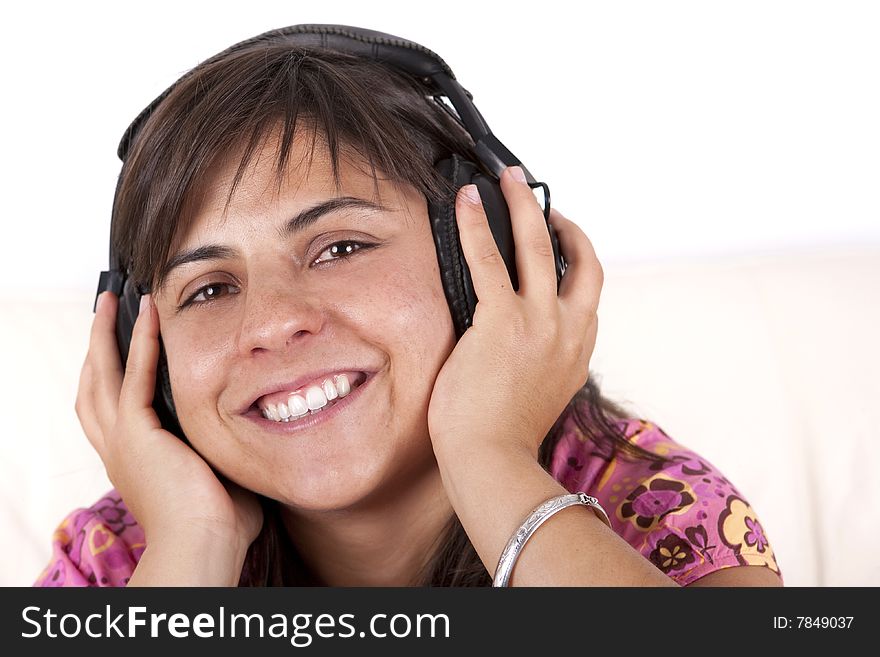 Young teenager smiling with music hearphones. Young teenager smiling with music hearphones