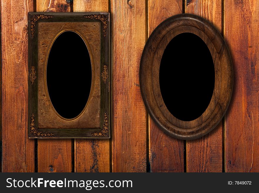 Two wintage photo-frames on wooden background