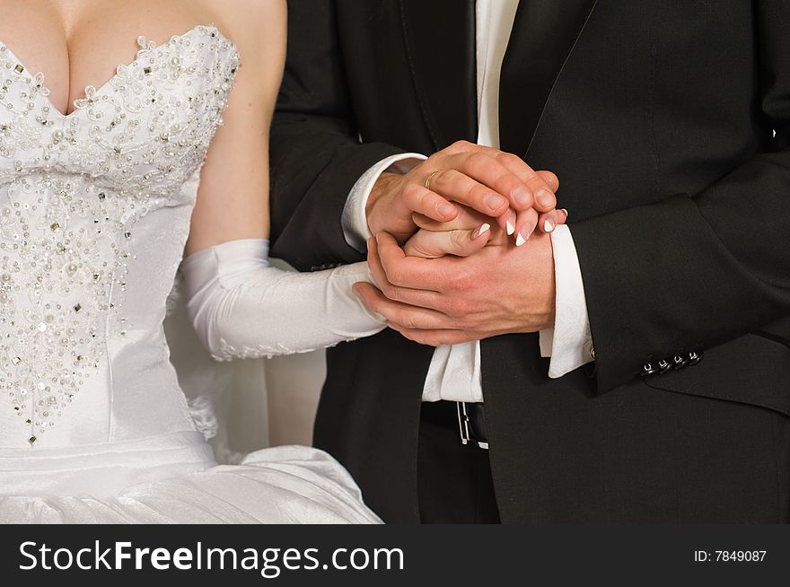 Gentle relations of a newly-married couple and their bound hands. Gentle relations of a newly-married couple and their bound hands.