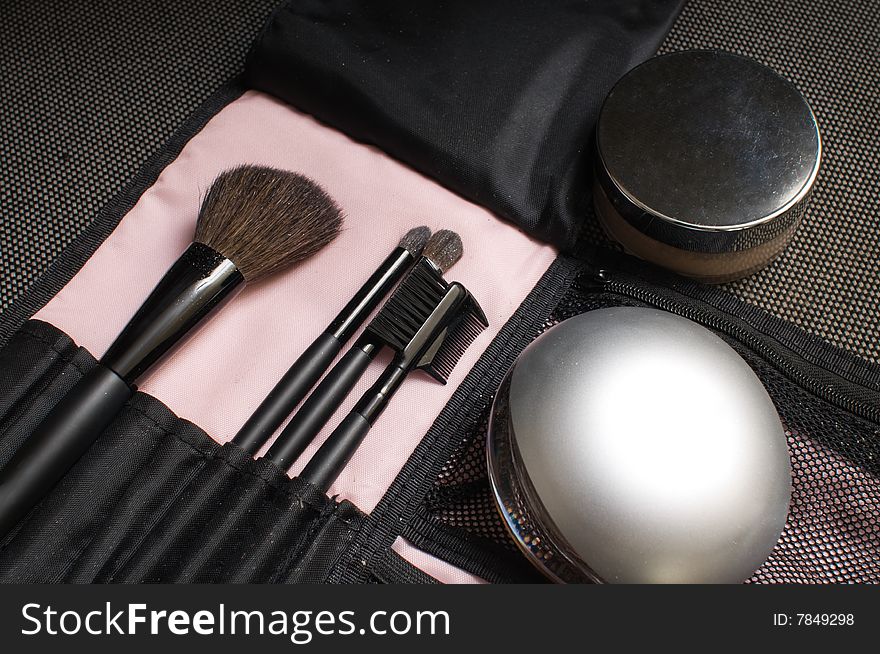 Brushes, a powder box and a cream for a make-up. Brushes, a powder box and a cream for a make-up.