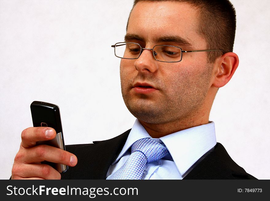 Young businessman on isolated background with his cell phone. Young businessman on isolated background with his cell phone