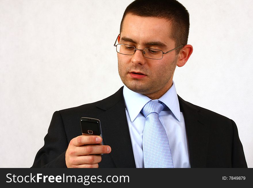 Young businessman on isolated background with his cell phone. Young businessman on isolated background with his cell phone