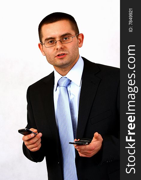 Young businessman on isolated background with a cell phones. Young businessman on isolated background with a cell phones