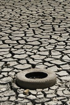 Cracked Ground Whit Tire. Global Warming Concept Royalty Free Stock Photography