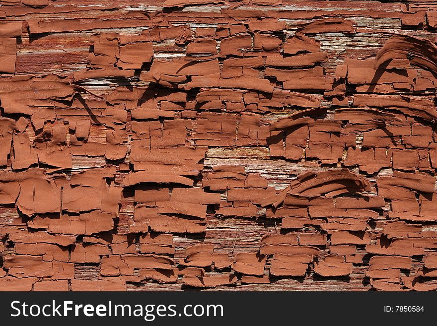 Old brown oil paint, peeling off a wooden wall. Old brown oil paint, peeling off a wooden wall