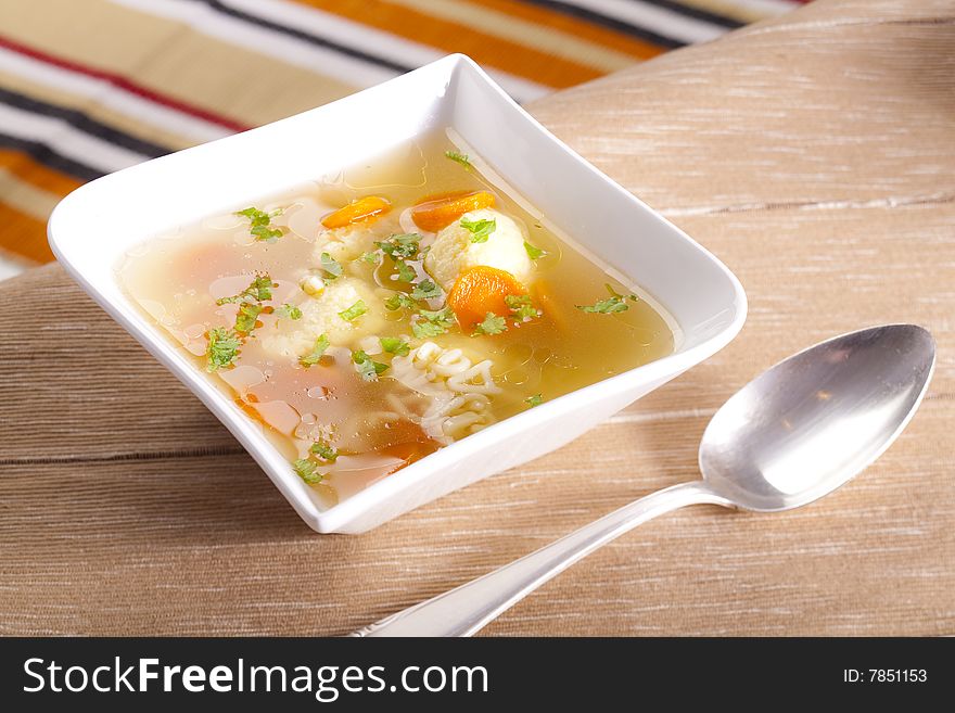 Noodle soup with dumplings and carrots