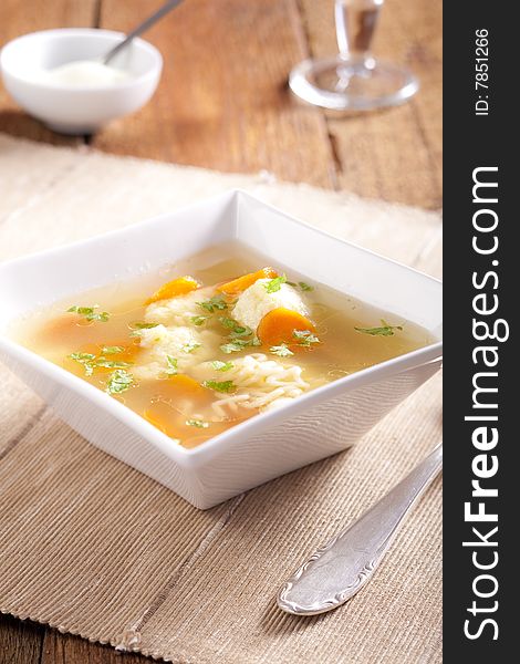 Noodle soup with dumplings and carrots