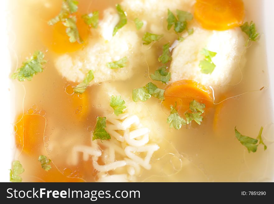 Noodle soup with dumplings and carrots