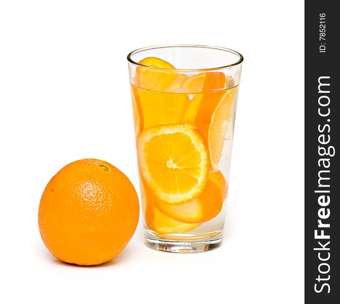 An orange and a glass of orange slices on white backgorund. An orange and a glass of orange slices on white backgorund.