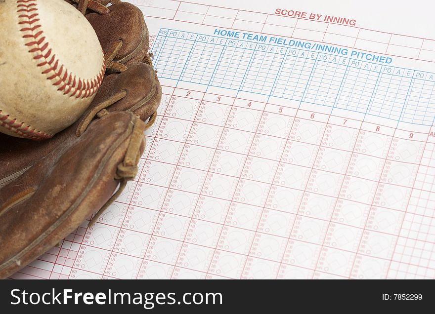 A picture of a ball and glove on a scorebook. A picture of a ball and glove on a scorebook