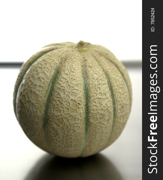 One melon fruit over a stainless steel table