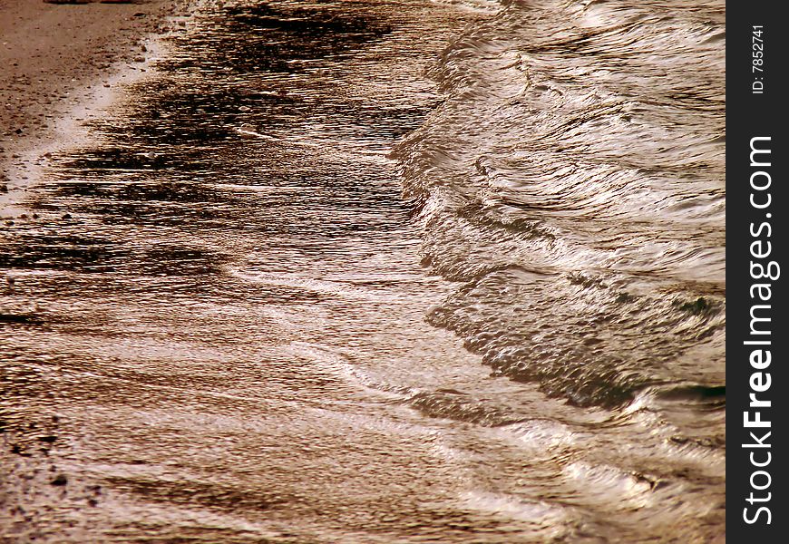 Waves make a lovely pattern on a beach in Bermuda, at sunset. Waves make a lovely pattern on a beach in Bermuda, at sunset.