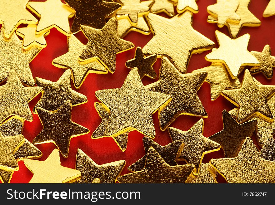 golden decoration with gold star over red background