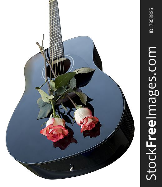 Two roses on a black guitar deck, isolated over white. Two roses on a black guitar deck, isolated over white