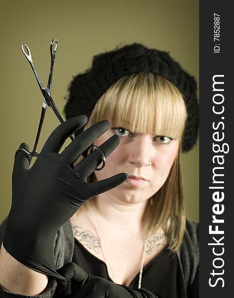 Woman Holding Forceps In Front Of Her Face