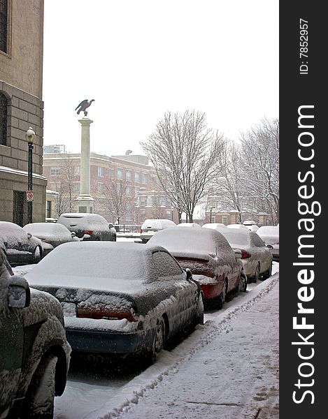 Snow covered cars line the street during snowstorm in boston massachusetts