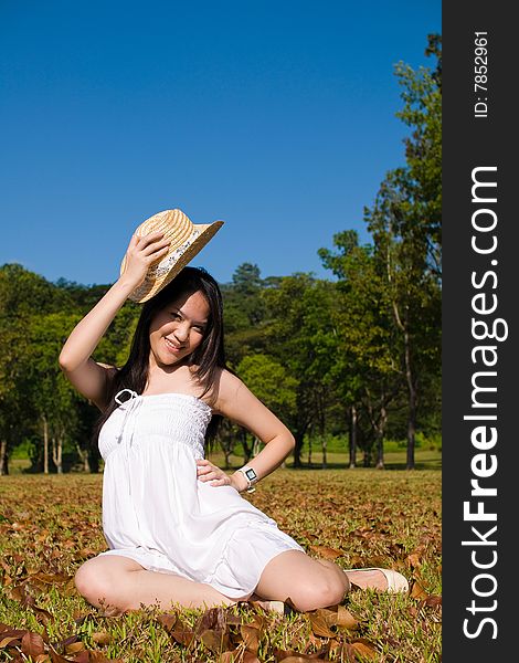 A beautiful asian girl enjoying the outdoor sun. A beautiful asian girl enjoying the outdoor sun