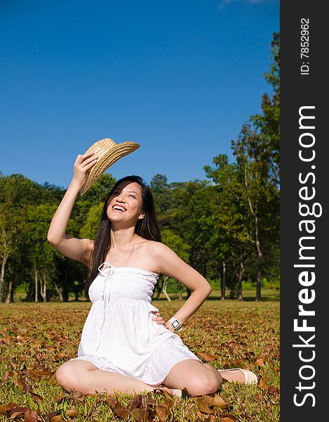 A beautiful asian girl enjoying the outdoor sun. A beautiful asian girl enjoying the outdoor sun