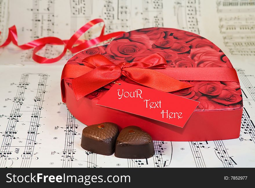 Celebrating Love - heart shaped chocolates over old classical music notes. Original RAW file available. Celebrating Love - heart shaped chocolates over old classical music notes. Original RAW file available