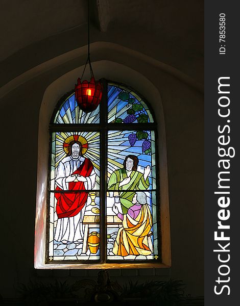 Colorful stained-glass window with figures of saints. Colorful stained-glass window with figures of saints